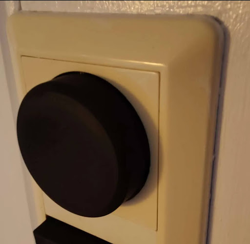 A picture showing a 3d printed dimmer on a wall